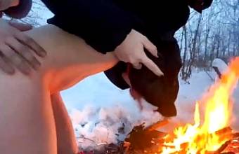 A guy and a girl fuck in the winter by the fire