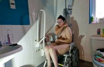 Paraplegic brunette milf Purplewheelz using catheters in the shower